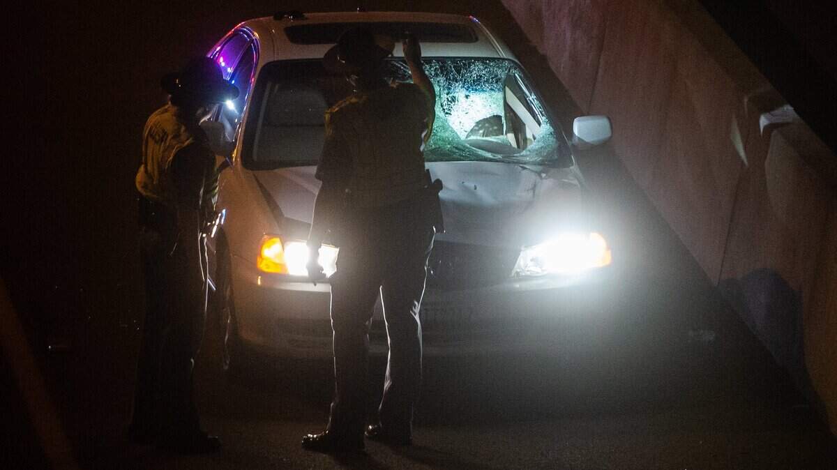 In this file photo, police investigate a fatal car collision.