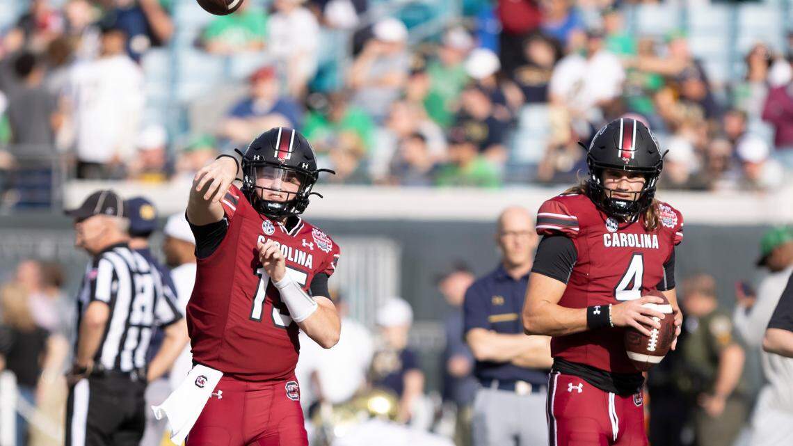 South Carolina Gamecocks quarterbacks Tanner Bailey (15) and Colten Gauthier (4) warm up before the Gator Bowl at TIAA Bank Field in Jacksonville, FL on Friday, Dec. 30, 2022.