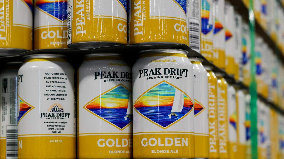 Cans of Peak Drift Golden blonde ale are stacked at the Peak Drift Brewing production facility in Columbia in this photo from Wednesday, Jan. 18, 2023.