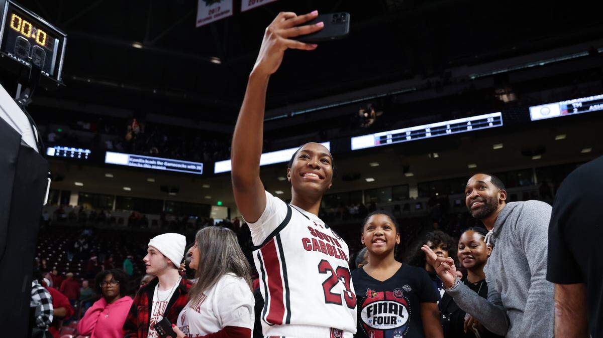 South Carolina guard Bree Hall (23) takes photos with fans following the Gamecocks’ game at Colonial Life Arena in Columbia on Saturday, December 16, 2023.
