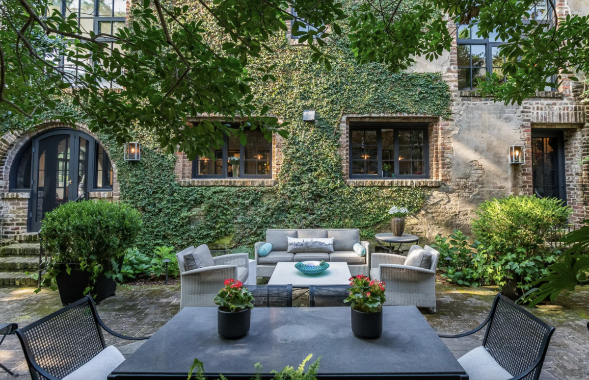 The backyard is surrounded by original brick.