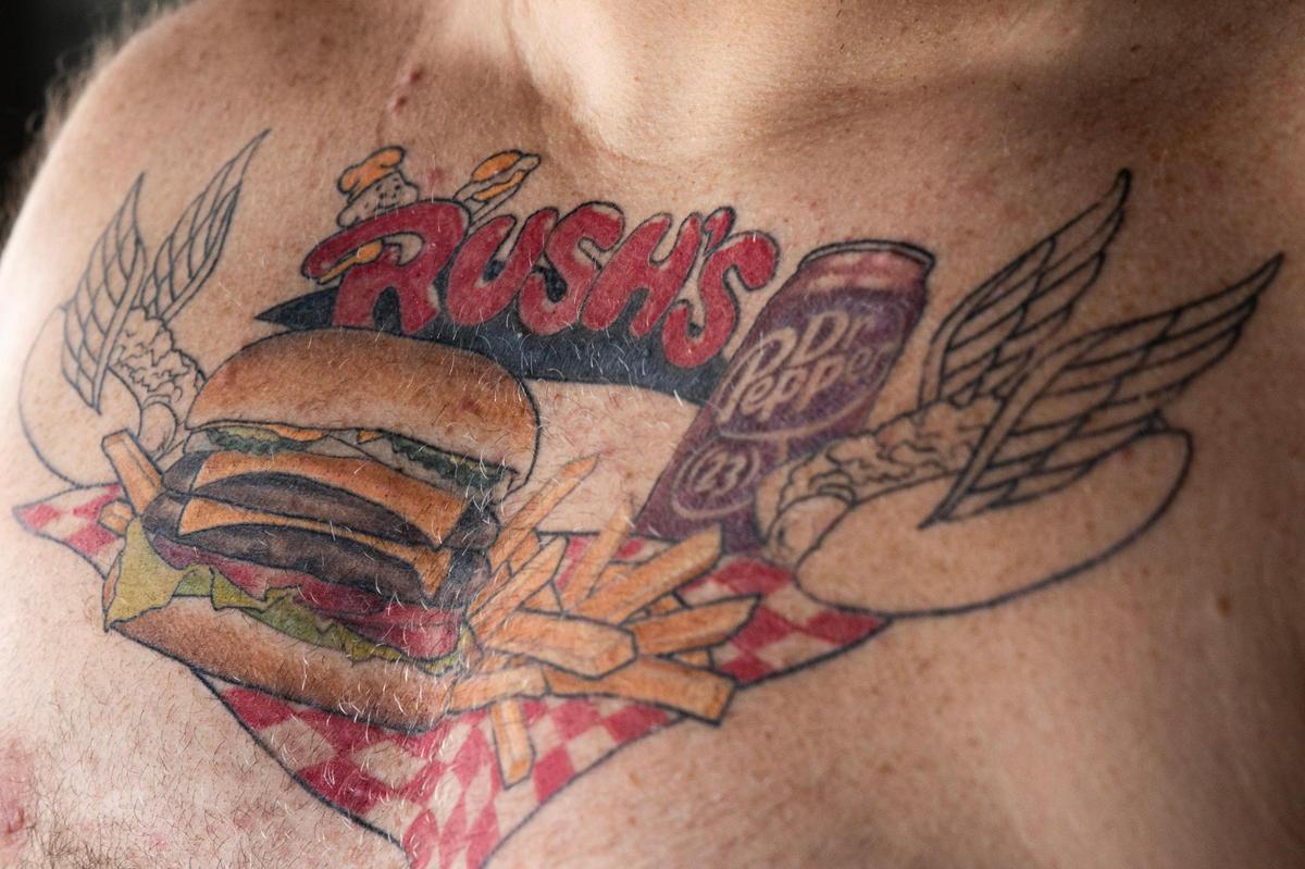 Nick Sielicki gets more color on a tattoo in honor of Columbia restaurant chain Rush’s at Southern Cypress Tattoo on Saturday, June 17, 2023.