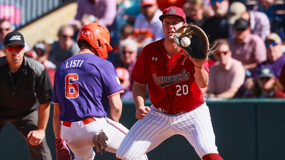 South Carolina infielder Ethan Petry (20) doesn’t catch the ball before Clemson outfielder Dominic Listi (6) makes it to first at Fluor Field in Greenville, South Carolina on Saturday, March 1, 2025.