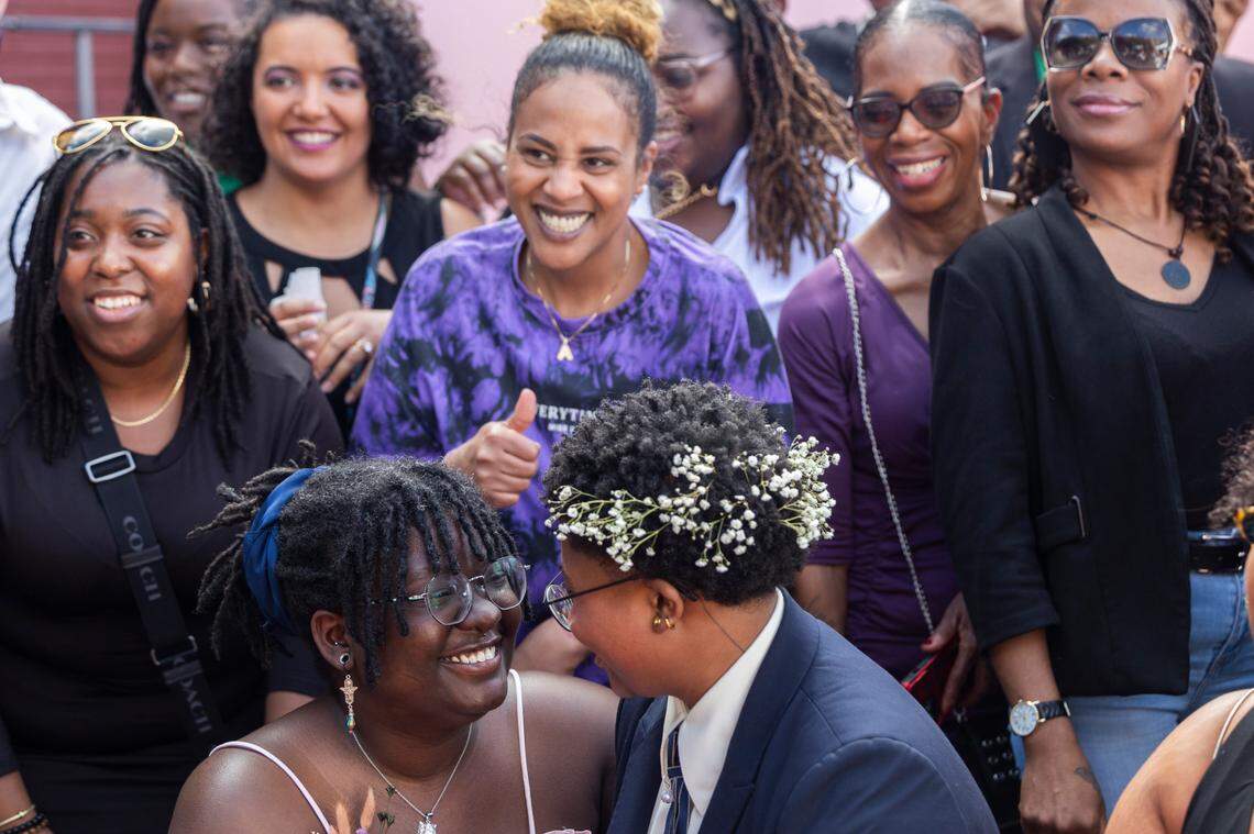 Mahkia Greene and Klo Hampton look at each other during photographs with their family after their wedding at Y’all-Mart, a quarterly art fair series, at Art Bar in Columbia, South Carolina on Sunday, February 9, 2025. Surrounded by close friends and family, attendees of the market also wished them well and congratulated them on their marriage.