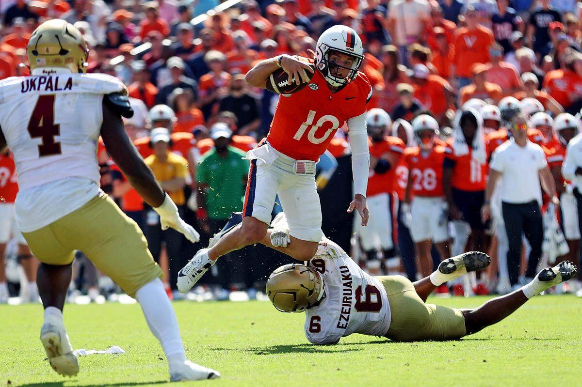 Oct 5, 2024; Charlottesville, Virginia, USA; Virginia Cavaliers quarterback Anthony Colandrea (10) is tackled by Boston College Eagles defensive end Donovan Ezeiruaku (6) during the third quarter at Scott Stadium.