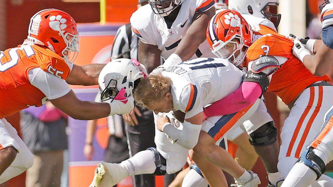 Clemson defensive tackle Payton Page (55) rips the helmet off of Virginia quarterback Anthony Colandrea (10) during first-half action in Clemson, S.C. on Saturday, Oct. 19, 2024.