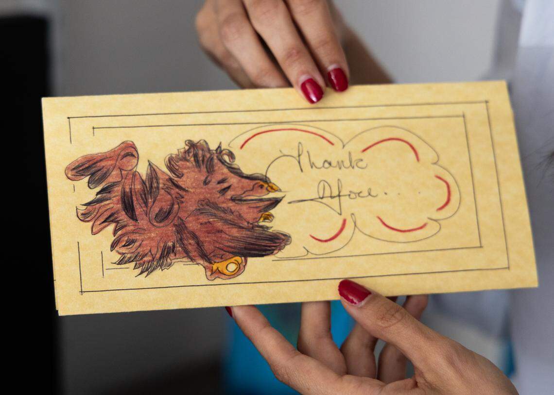 Christina Plakas shows a card Ben Case sent to her from prison.