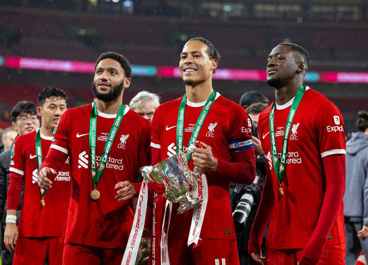 Liverpool’s Joe Gomez (Front, L), captain Virgil Van Dijk (Front, C) and Ibrahima Konate (Front, R) celebrate with the trophy after the English Football League Cup final match between Chelsea and Liverpool in London, Britain, on Feb. 25, 2024.