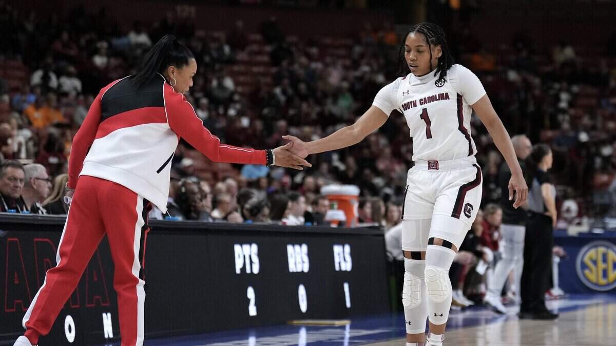 South Carolina Gamecocks head coach Dawn Staley gives a hand slap to guard Zia Cooke (1) in the first quarter at Bon Secours Wellness Arena.