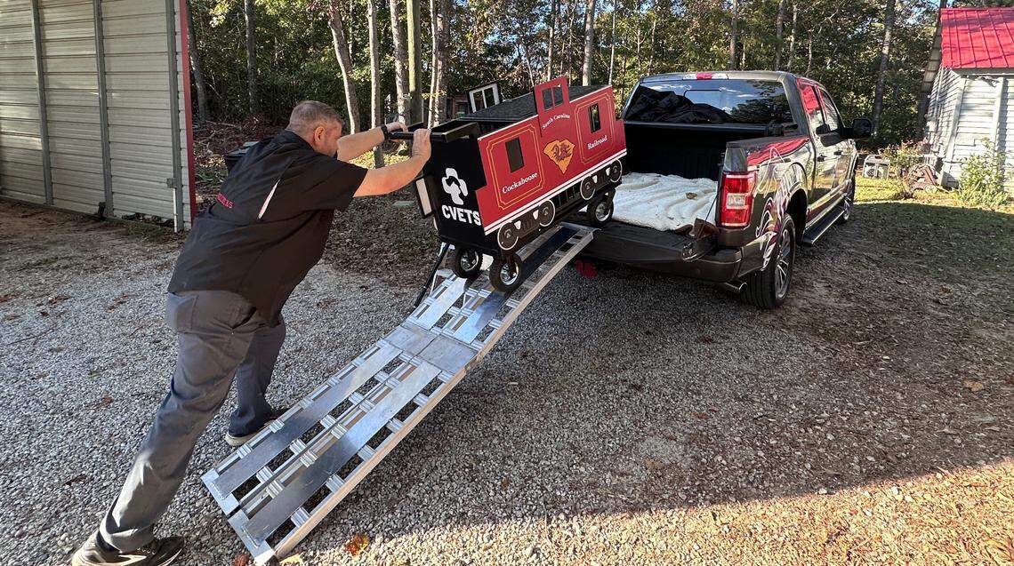 Van Clark, caretaker of Sir Big Spur, loads up the rooster’s perch into his truck.