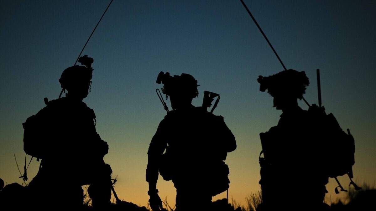 Soldiers discuss mission plans before moving to a simulated objective during training at Pohakuloa Training Area, Hawaii, Oct. 18, 2021.
