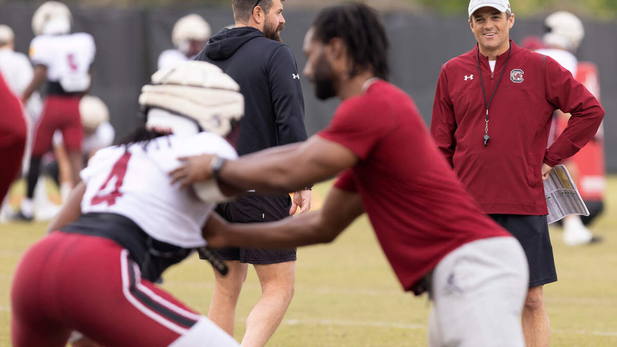 South Carolina head coach Shane Beamer speaks with strength and conditioning coach Luke Day during the Gamecocks’ practice in Columbia on Thursday, March 23, 2023.