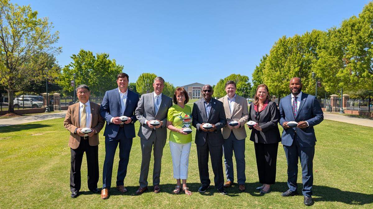 Local leaders including, from left, Jimmy Chao, Lexi Boone, Mayor Daniel Rickenmann, Miriam Atria, Paul Livingston, Jason Branham, Jan Jernigan, and Tyler Bailey were on hand for the Wednesday announcement of the 2026 Southerastern BBQ Showdown at Gamecock Park in Columbia.