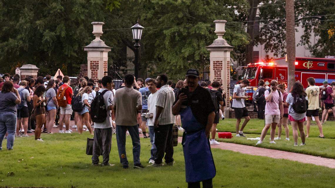 Students and staff congregate on the USC Horseshoe after being evacuated from the Russell House after reports of the sounds of gunfire on the University of South Carolina campus at the Thomas Cooper Library on Sunday, August 25, 2025.