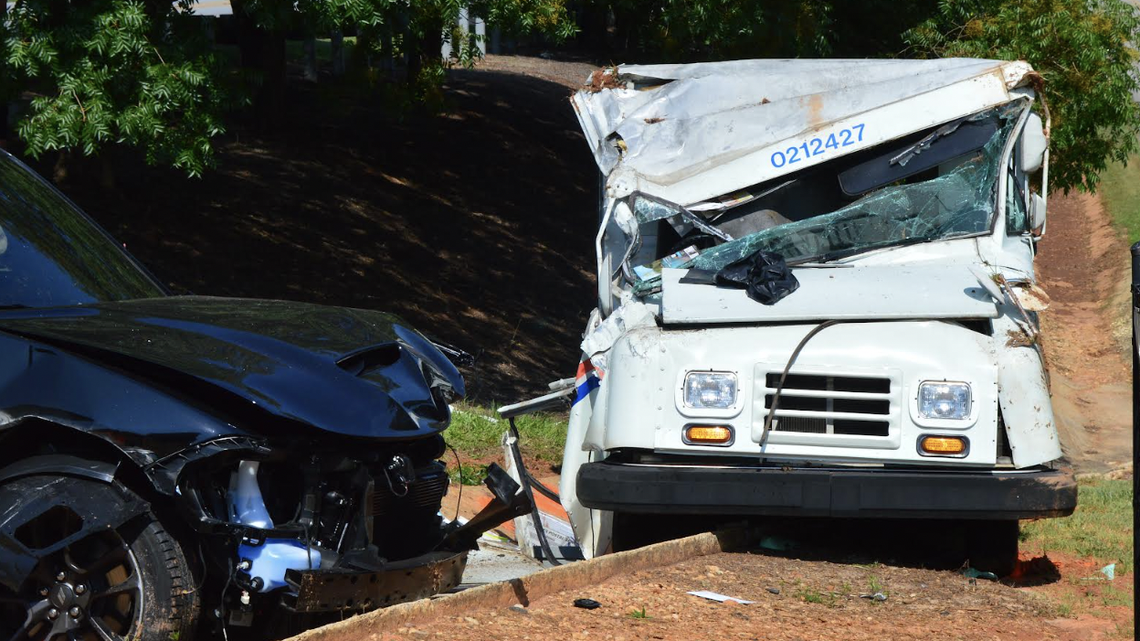 The U.S. Postal Service vehicle after the crash with Dodge Charger to the left.