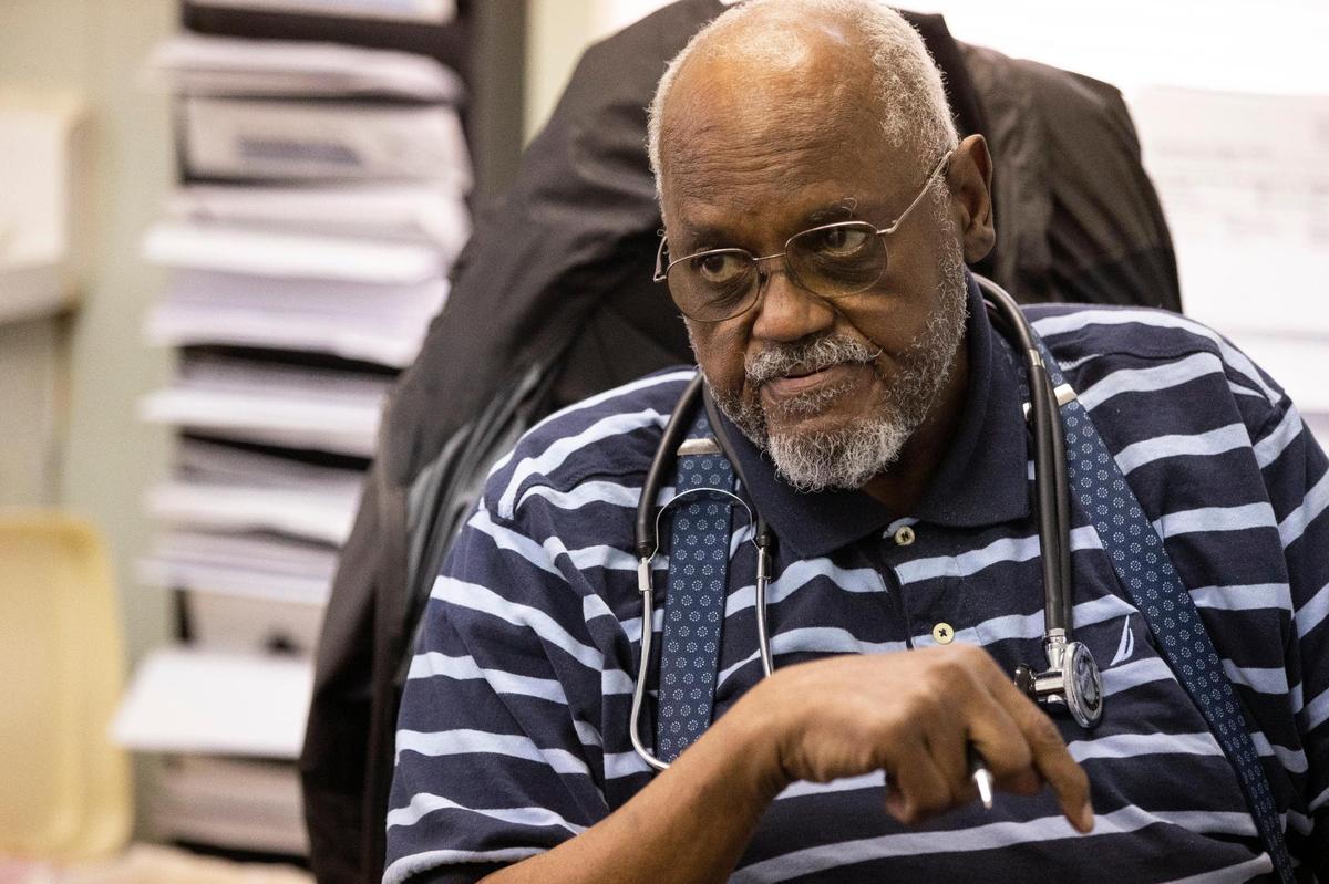 Dr. Green Neal speaks with a patient at a clinic in early April.