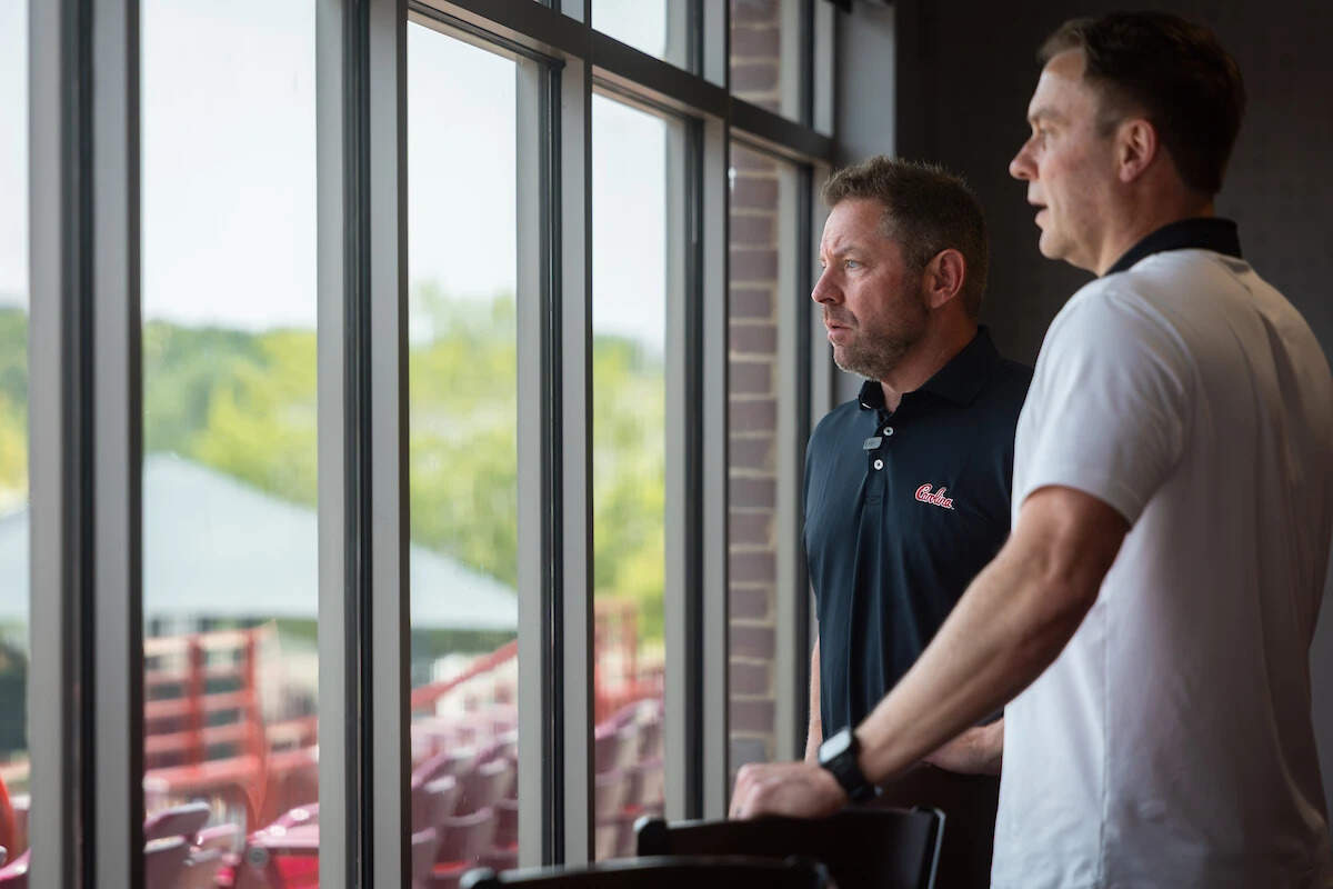 New South Carolina baseball coach Kevin Schnall (left) and athletic director Jeremiah Donati (right) at Founders Park