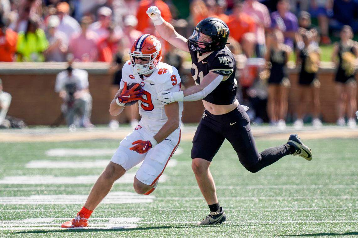 Wake Forest Demon Deacons linebacker Branson Combs (21) tries to stop Clemson Tigers tight end Jake Briningstool (9) during the first half at Allegacy Federal Credit Union Stadium.