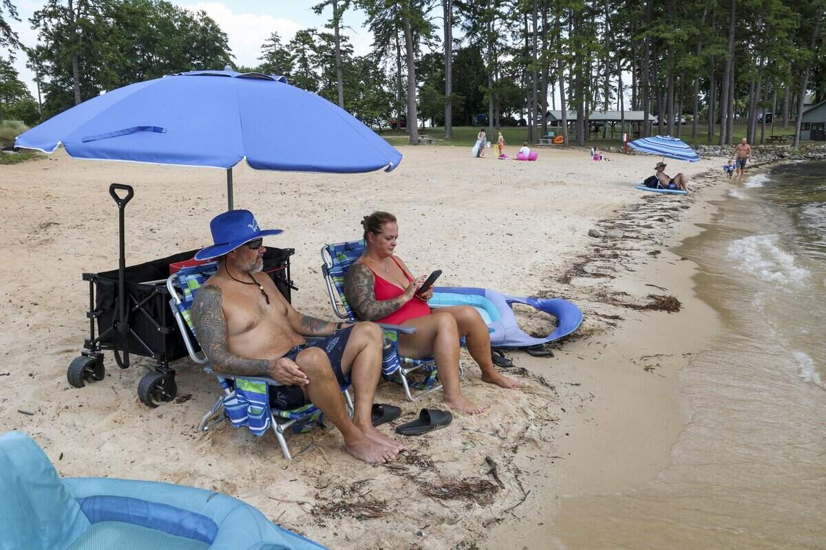 Allan and Christy Woloskie relax at at Pine Island State Park on Thursday, July 9, 2026. Living close by, they frequent the beach about every day the park is open. The park is open Thursday thru Sunday, 9 a.m. to 6 p.m.