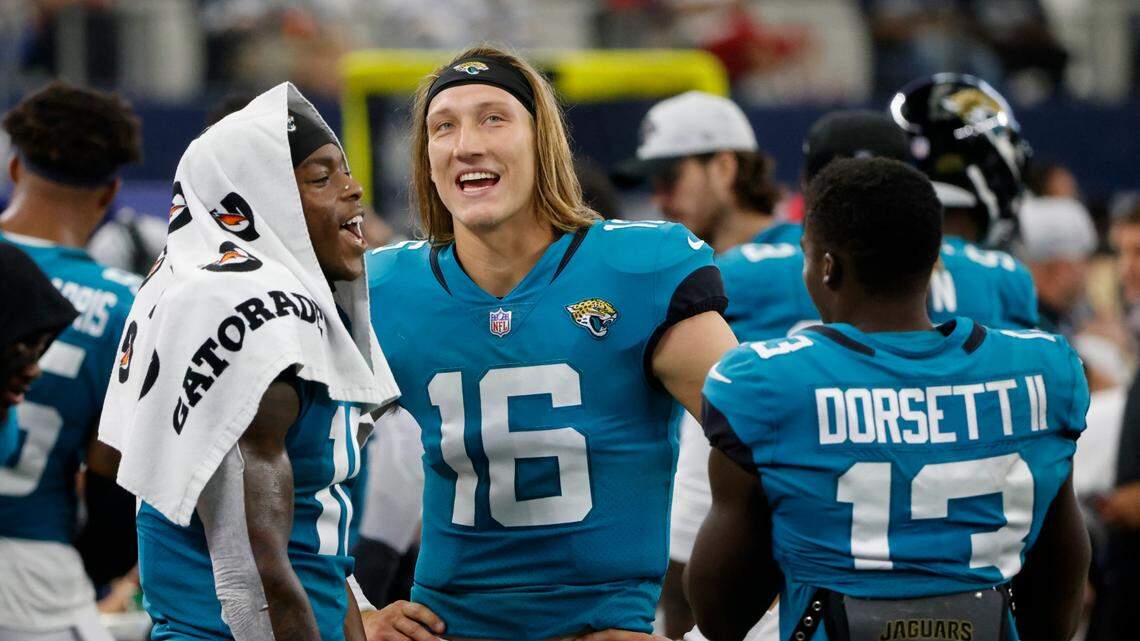 Jacksonville Jaguars’ Laviska Shenault Jr., left, Trevor Lawrence (16) and Phillip Dorsett II (13) talk on the sideline in the first half of a preseason NFL football game against the Dallas Cowboys in Arlington, Texas, Sunday, Aug. 29, 2021. (AP Photo/Michael Ainsworth)