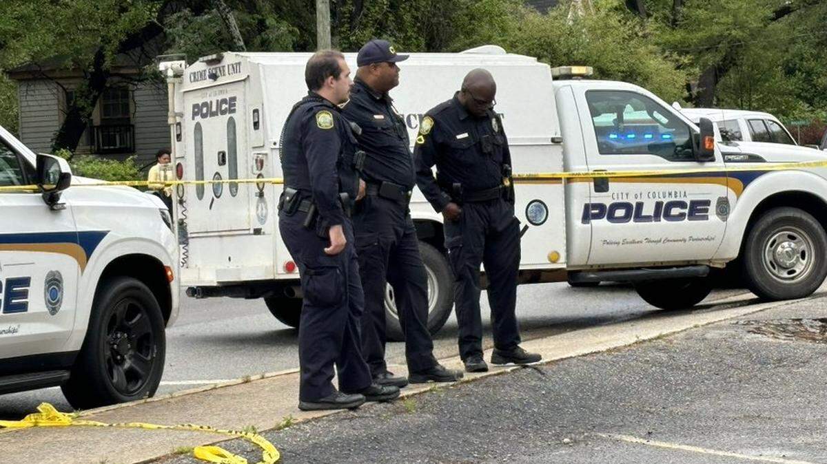 Columbia police officers at the scene of where a woman’s body was found inside a garbage can behind a convenience store on April 11, 2024.
