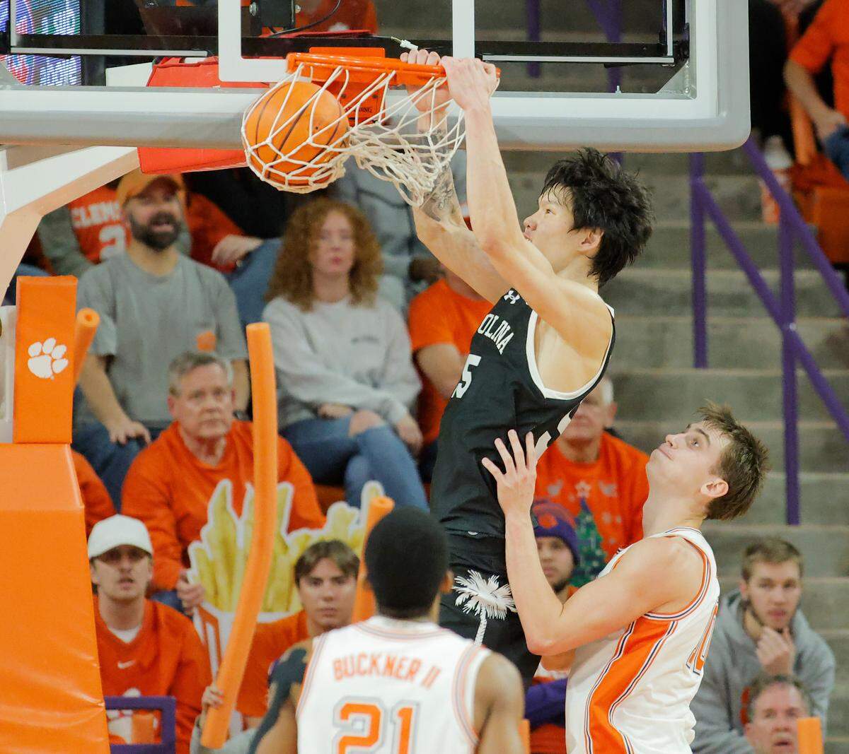 South Carolina guard Mike Sharavjamts (55) dunks over Clemson forward Jake Wahlin (10) during second-half action in Clemson, S.C. on Tuesday, Dec. 16, 2025.