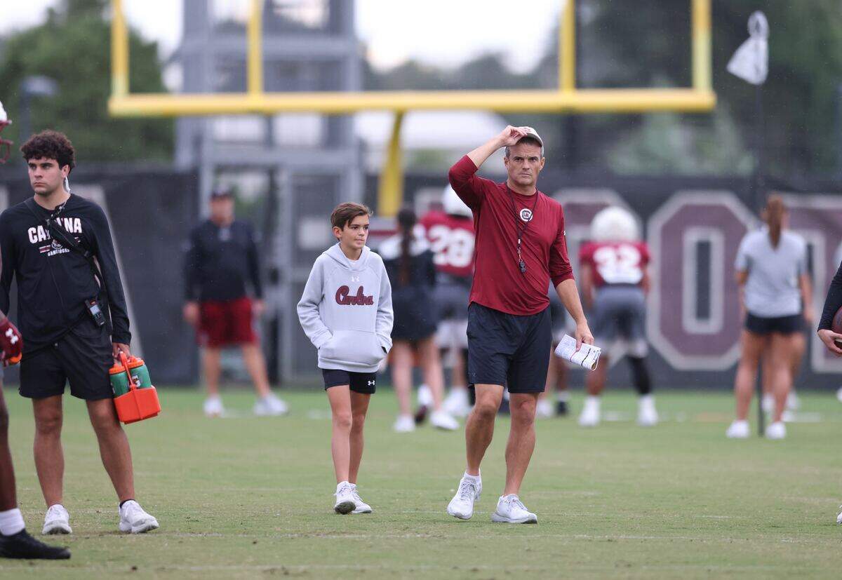 Shane Beamer and son Hunter look on Sunday during the South Carolina football team’s latest practice.