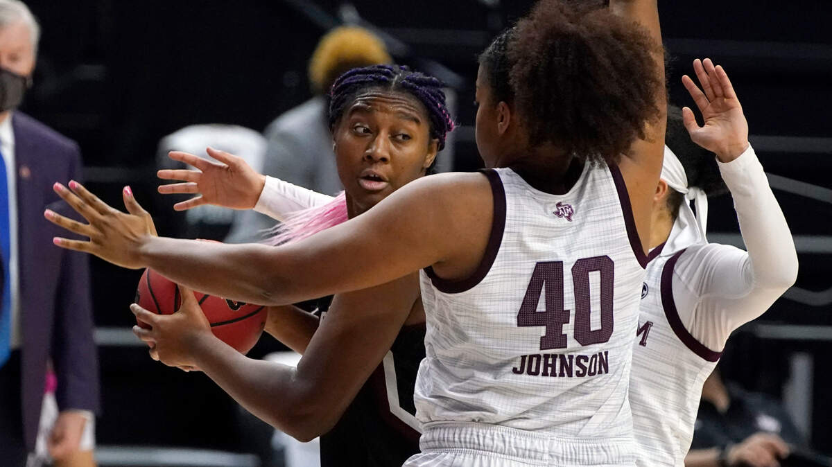 South Carolina forward Aliyah Boston (4) looks to pass against Texas A&M center Ciera Johnson (40) during the first half of an NCAA college basketball game Sunday, Feb. 28, 2021, in College Station, Texas. (AP Photo/Sam Craft)