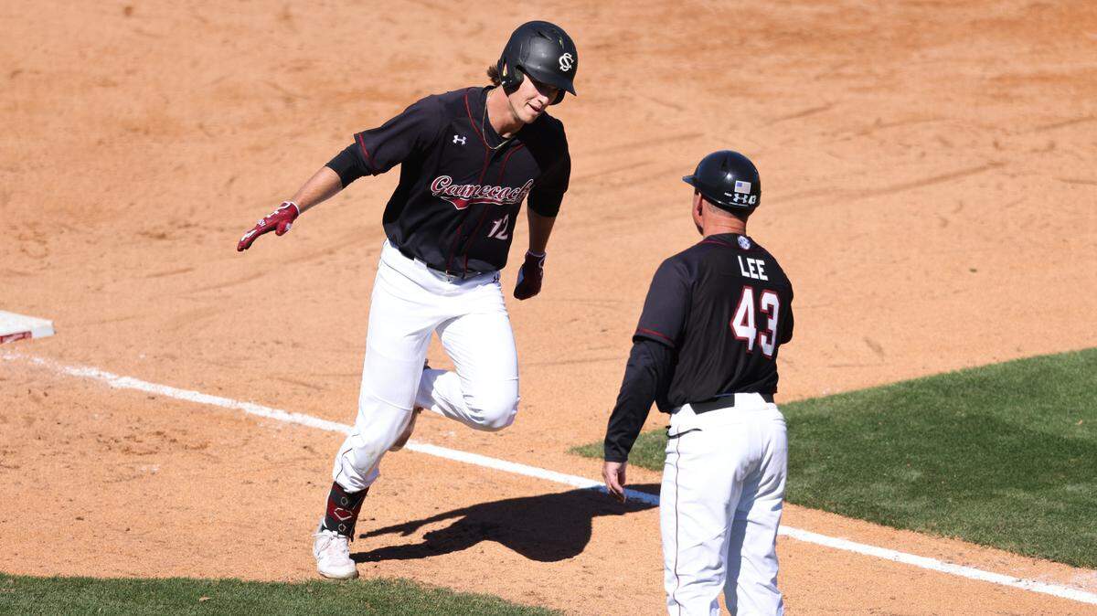 South Carolina infielder Tyler Causey (12) gets a high-five from assistant coach Monte Lee while rounding the bases after hitting a home run during the Gamecocks’ game against Longwood at Founders Park in Columbia on Sunday, March 10, 2024.