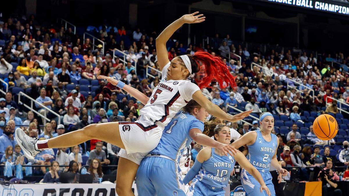 South Carolina’s Victaria Saxton (5) falls back on North Carolina’s Alyssa Ustby (1) during the first half of action during the Sweet 16 game at the the Greensboro Coliseum on Friday, March 25, 2022.