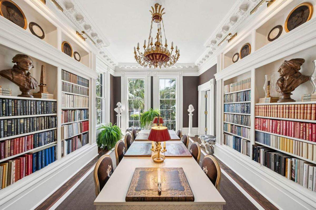 A large room with plenty of bookshelves in a $12.5 million Charleston home for sale.