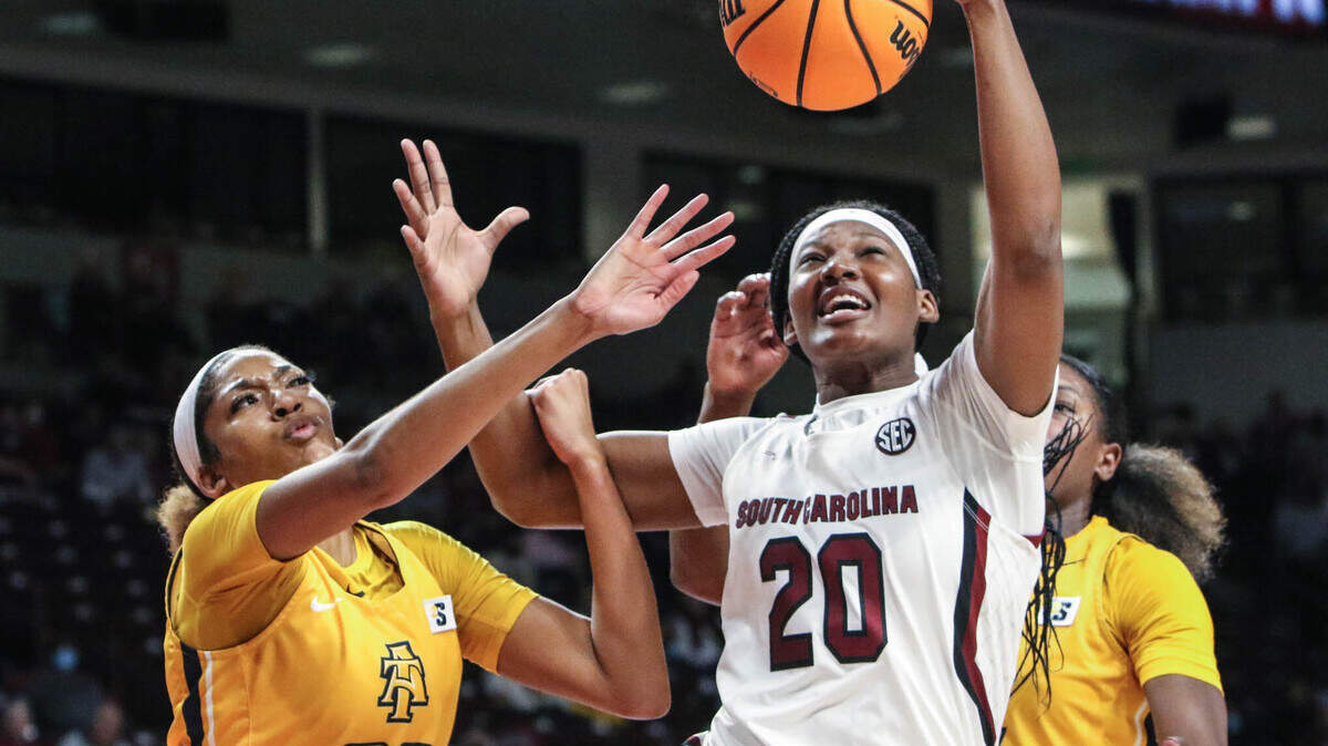 South Carolina’s Sania Feagin (20) pulls down a rebound as North Carolina A&T’s Rochelle Lee pressures (32) during the second half of action on Monday, Nov. 29, 2021 in the Colonial Life Arena. USC won, 79-42.