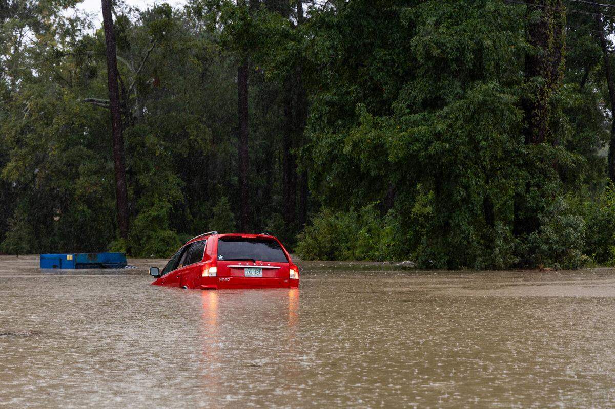 A red Volvo is halfway submerged in Forest Acres as Hurricane Helene hits Columbia, South Carolina on Thursday, September 26, 2024.