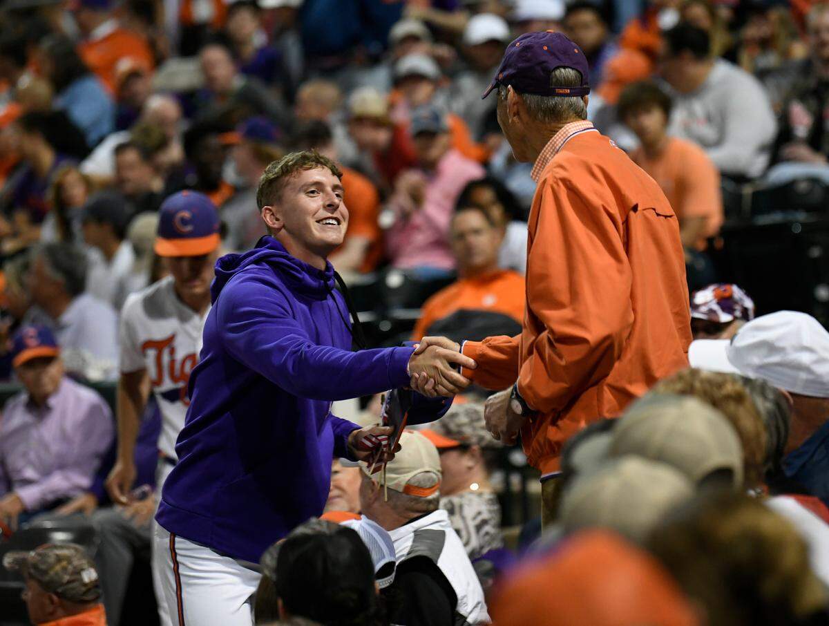Clemson’s Briggs Sullivan shakes hands with US Army veteran Webb Jones of Florence between innings of the Tiger’s baseball game against Georgia Tuesday, April 22, 2025, at Clemson’s Doug Kingsmore Stadium.