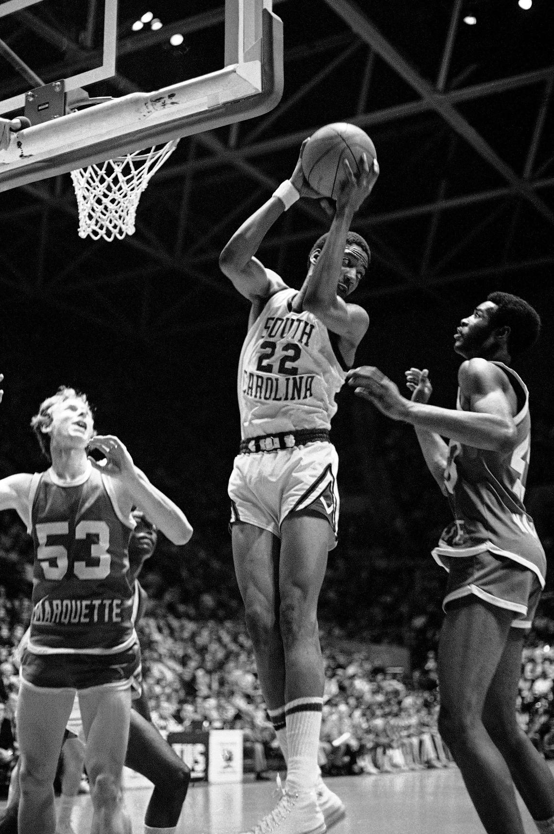 Alex English of the University of South Carolina, left, hangs on to the rebound in a face to face struggle with Earl Tatum (43) of Marquette in game action on Feb. 22, 1975 at Carolina Coliseum in Columbia. (AP Photo/LK)
