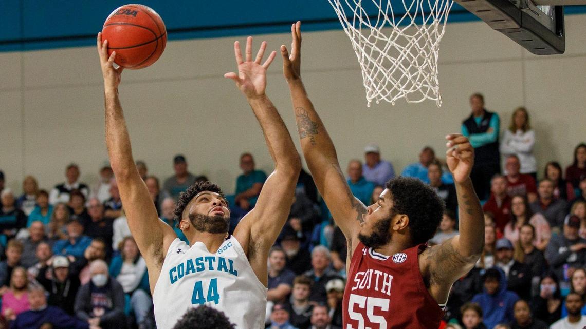 Coastal’s Essam Mostafa goes up against South Carolina’s Ta’Quan Woodley. The Coastal Carolina Chanticleers of the Sun Belt Conference hosted the South Carolina Gamecocks of the SEC in college basketball Wednesday night at the HTC Center in Conway, SC for the first time. Dec. 1, 2021.