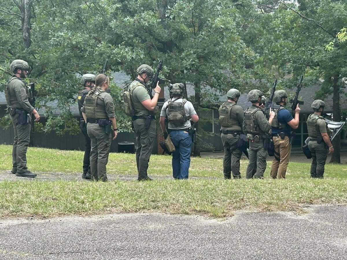 Members of law enforcement respond to an armed standoff.