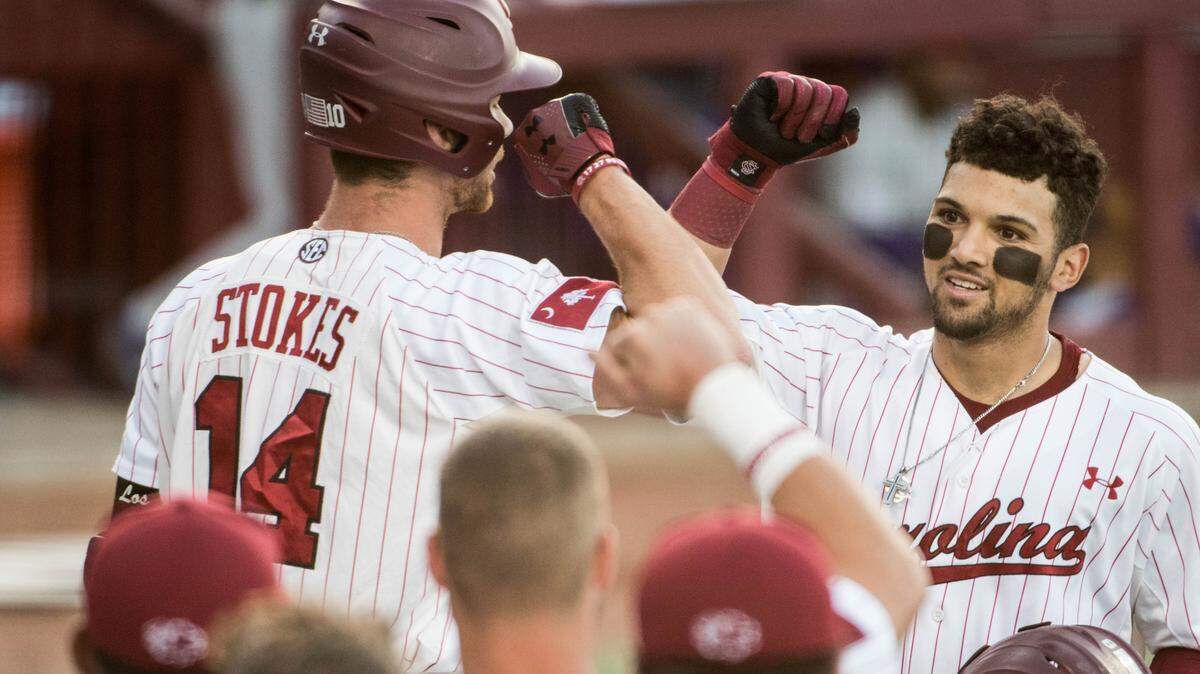 South Carolina outfielder Carlos Cortes, right, celebrates his first inning home run against LSU at Founders Park April 20, 2018, in Columbia, S.C.