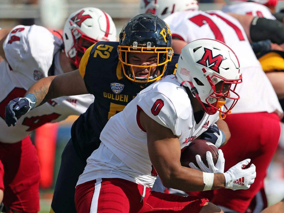 Kent State Golden Flashes defensive lineman John Jackson (52) brings down Miami (Oh) Redhawks running back Rashad Amos (0) during the first half of an NCAA football game at Dix Stadium, Saturday, Sept. 30, 2023, in Kent, Ohio.