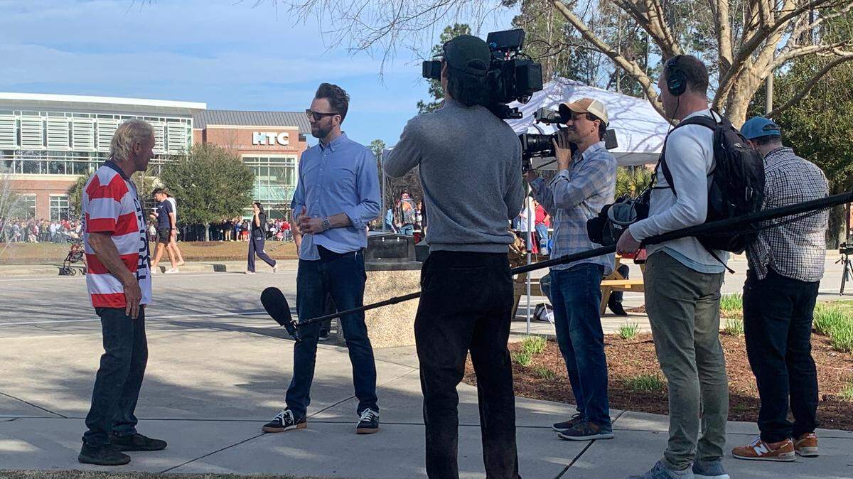 The Daily Show correspondent Jordan Klepper interviews an attendee outside of former President Donald Trump’s rally in Conway, S.C. on Saturday, Feb. 10, 2024.