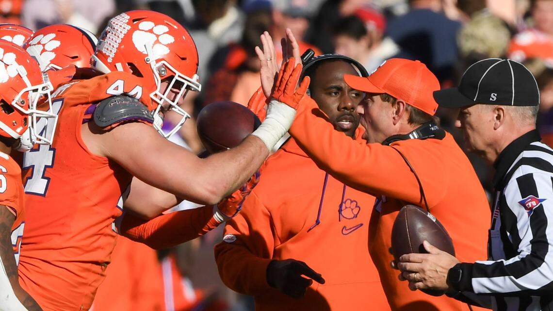 Nov 30, 2024; Clemson, South Carolina, USA; Clemson head coach Dabo Swinney high fives Clemson defensive end Cade Denhoff (44) during the fourth quarter at Memorial Stadium.