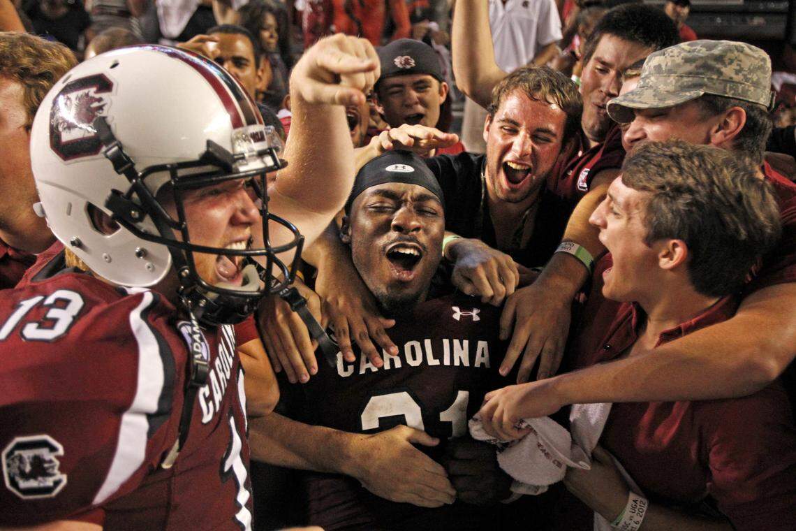 South Carolina Gamecocks running back Marcus Lattimore (21) celebrates with fans after jumping into them following the Gamecocks 35-7 win over Georgia in 2012 at Williams-Brice Stadium in Columbia, SC.