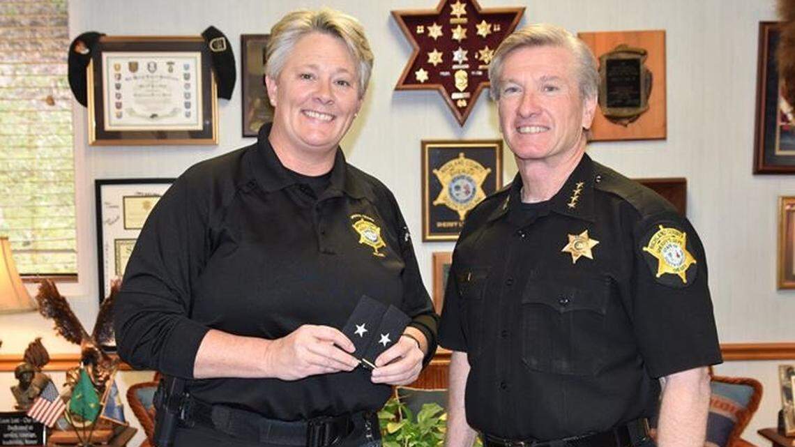 Deputy Chief Roxana Meetze, left, upon receiving her promotion from Richland County Sheriff Leon Lott.