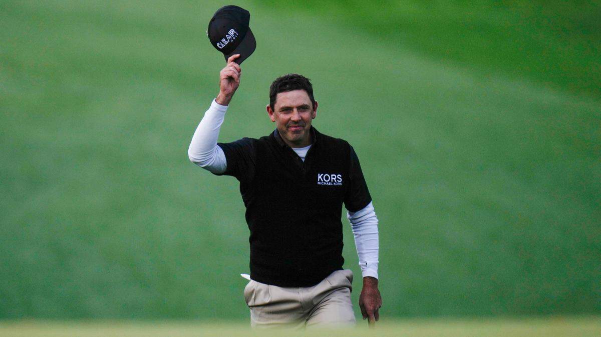 Charl Schwartzel, of South Africa, waves after making an eagle from the 10th fairway during the third round at the Masters golf tournament on Saturday, April 9, 2022, in Augusta, Ga. (AP Photo/Jae C. Hong)