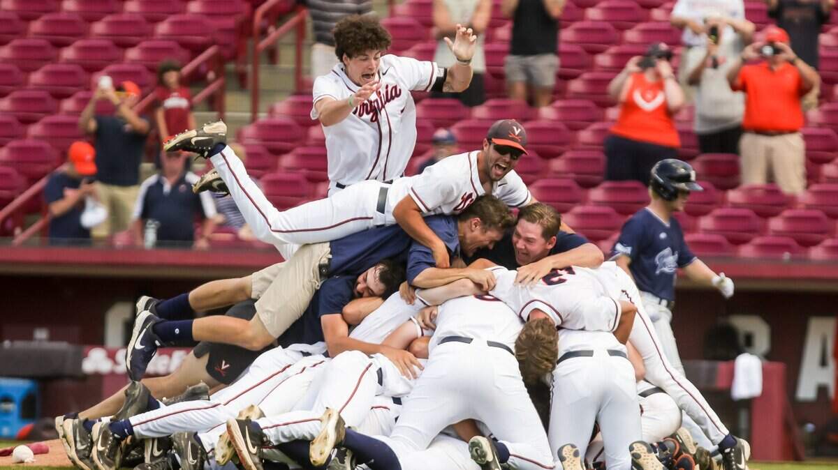 Virginia Cavaliers players celebrate winning their Super Regional clinching game against the Dallas Baptist Patriots. The win sends them to the College World Series.