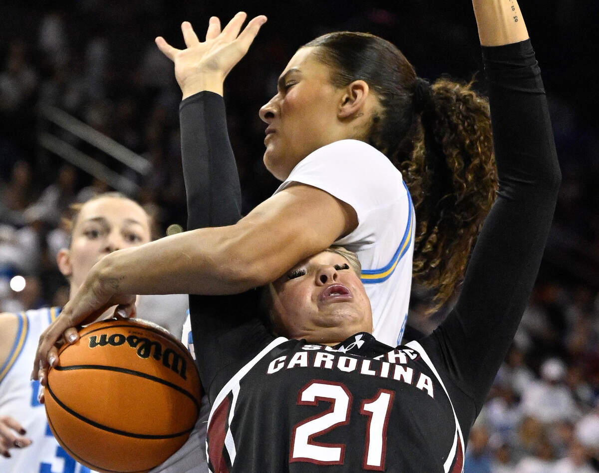 Nov 24, 2024; Los Angeles, California, USA; South Carolina Gamecocks forward Chloe Kitts (21) and UCLA Bruins center Lauren Betts (51) battle for a rebound during the first quarter at Pauley Pavilion presented by Wescom. Mandatory Credit: Robert Hanashiro-Imagn Images