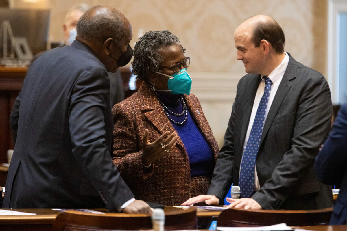 Bill Clyburn D-Aiken, Gilda Cobb-Hunter D-Orangeburg and Patrick Dennis, chief of staff and general council to the speaker of the house, talk at the South Carolina State House on January 11, 2022.