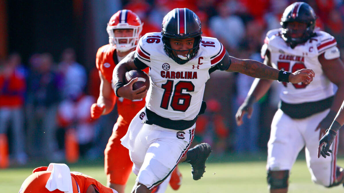 University of South Carolina quarterback LaNorris Sellers (16) avoids being tackled by Clemson cornerback Tavoy Feagin on Saturday, Nov. 30, 2024. 