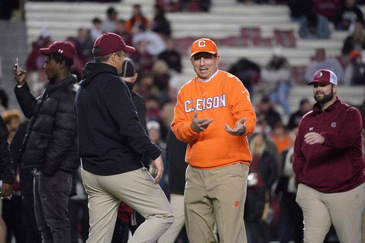 Clemson head coach Dabo Swinney, right, talks with South Carolina head coach Shane Beamer before an NCAA college football game Saturday, Nov. 27, 2021, in Columbia, S.C. Clemson won 30-0. (AP Photo/Sean Rayford)