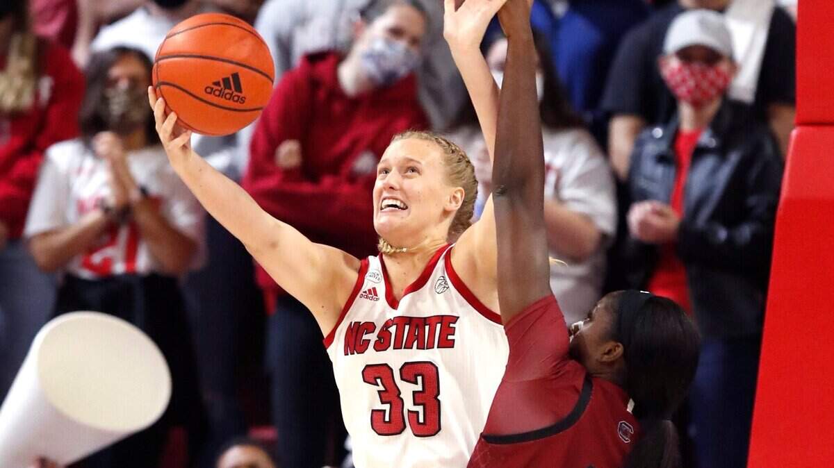 N.C. State’s Elissa Cunane (33) shoots as South Carolina’s Victaria Saxton (5) defends during the first half of N.C. States game against South Carolina at Reynolds Coliseum in Raleigh, N.C., Tuesday, November 9, 2021.
